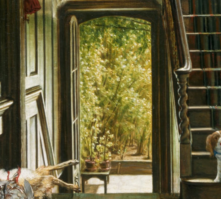 Detail showing the open door at the back of the house, where a small table holds two pots of plants. Beyond is a grove of leafy trees. 